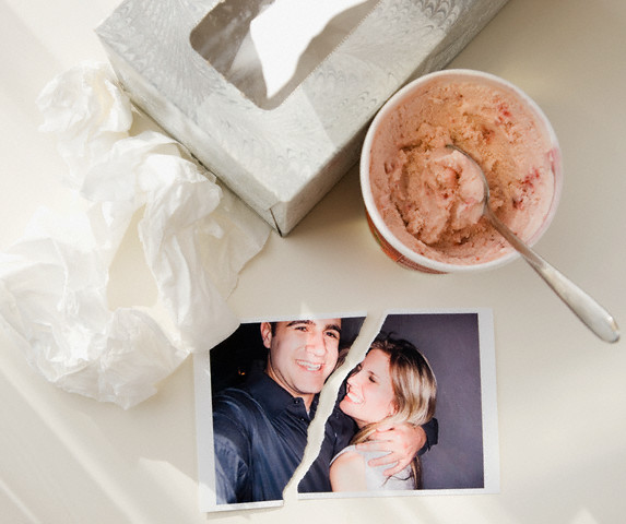 Ripped photograph next to ice cream and tissues