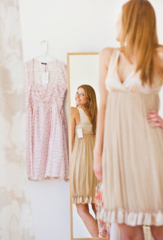 USA, New Jersey, Jersey City, Young woman in clothes shop fitting dress
